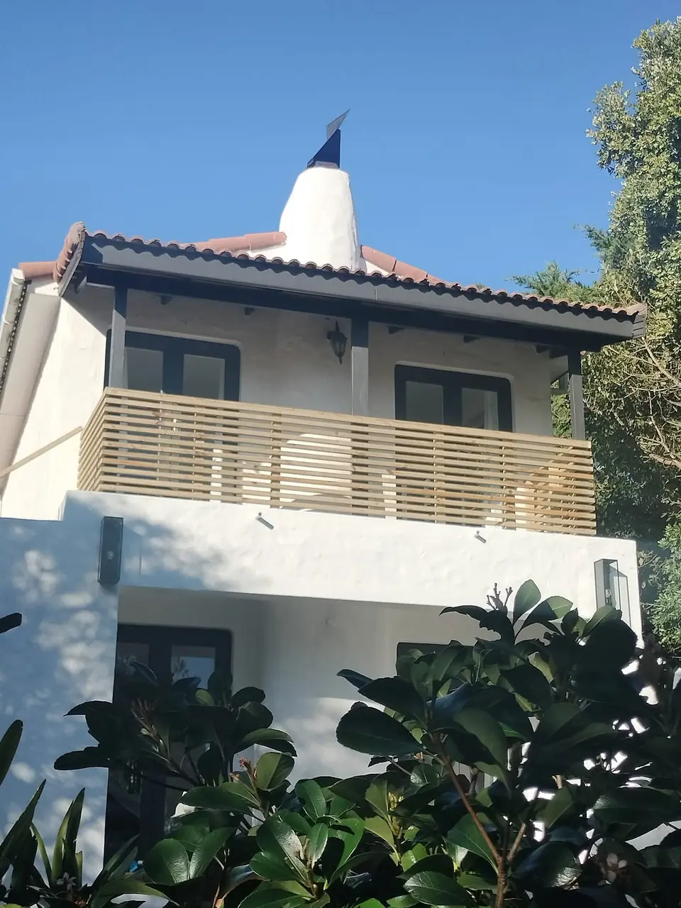 Slatted timber balcony screen on a white house