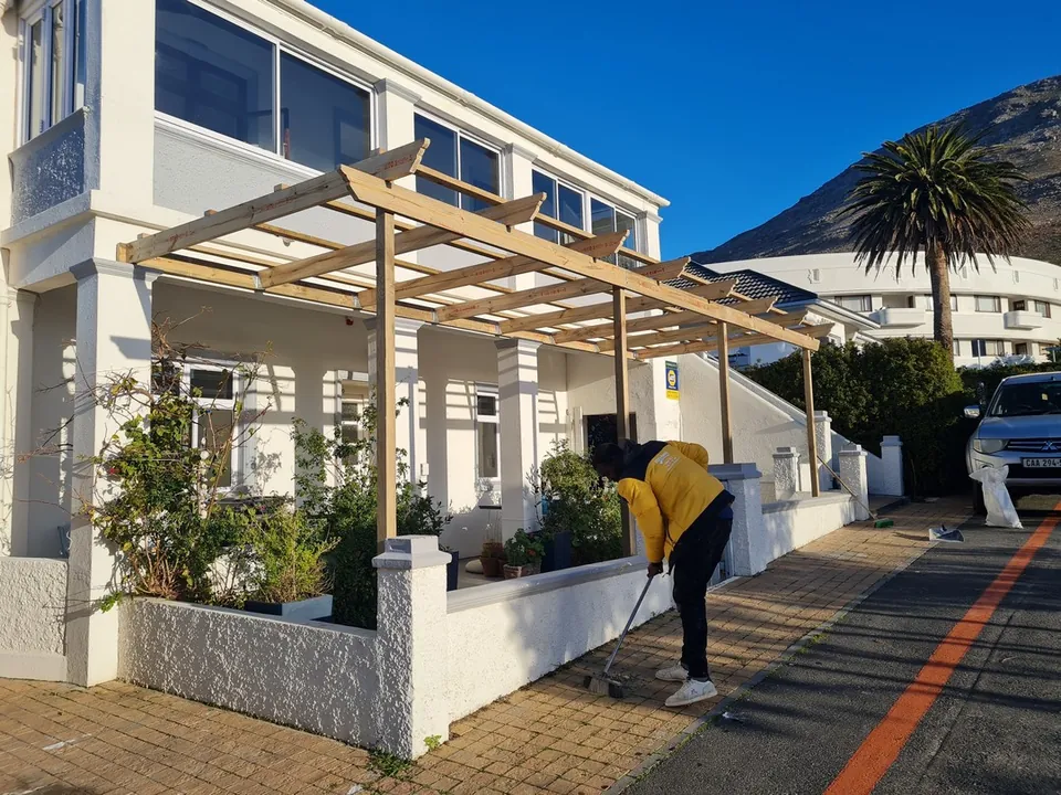 Timber pergola on the front of a white house in Simon's Town