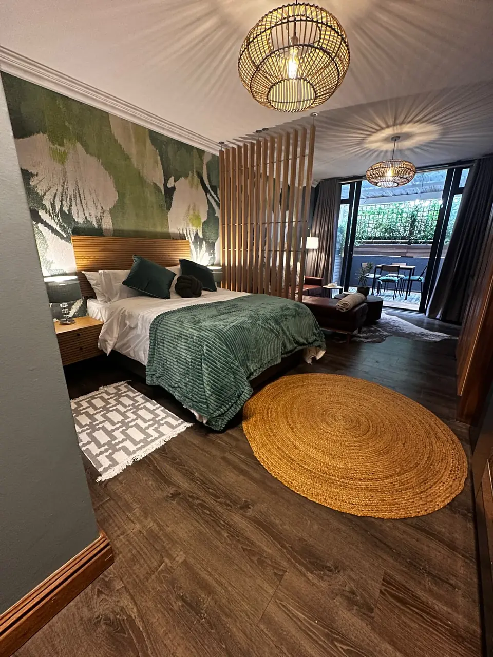 Renovated bedroom with timber floors and a slatted timber divider