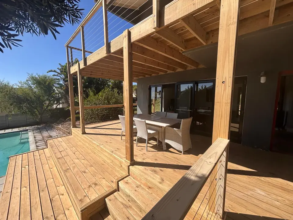 Timber deck with steps beside a swimming pool