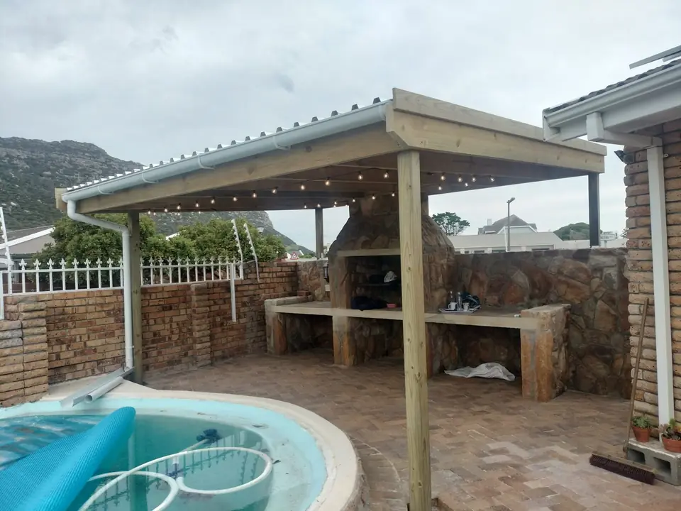 Timber pergola over a braai area beside a plunge pool