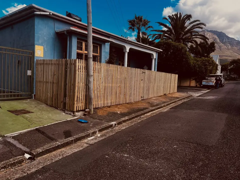 Timber picket fence along the front of a house on a sloping street