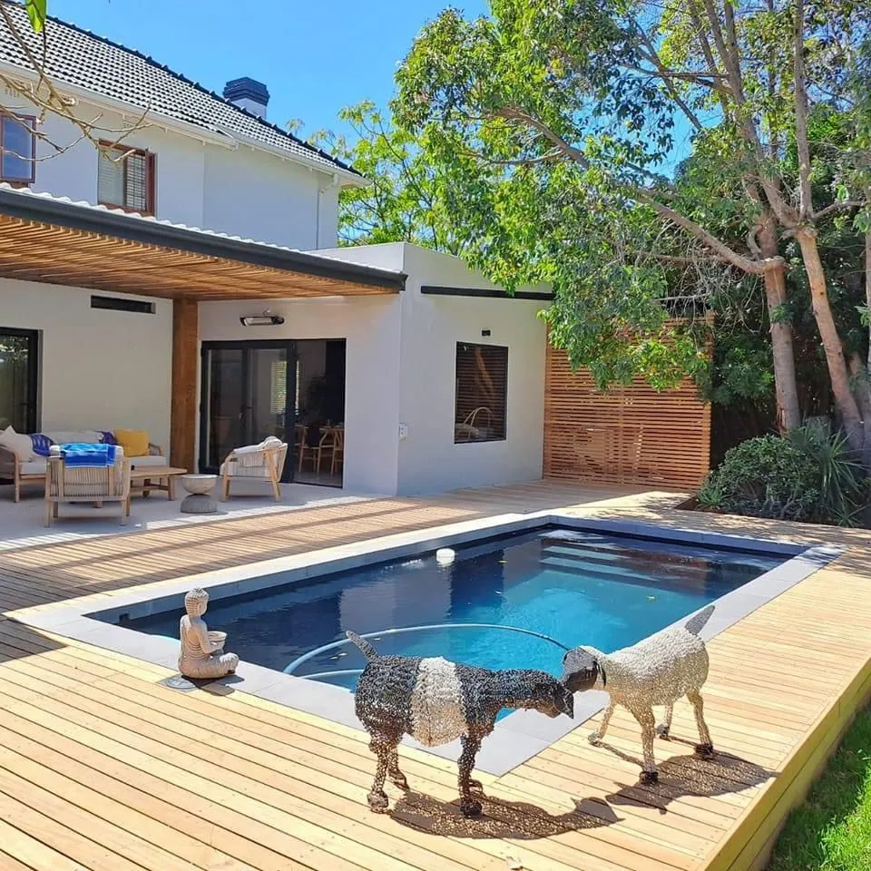 Timber pool deck with a pergola and slatted timber screen